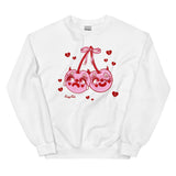 White cotton and polyester crew neck sweat shirt featuring pink and red clown cherries with devil horns with one face sad and crying and other happy and winking. The cherries character is surrounded by red hearts