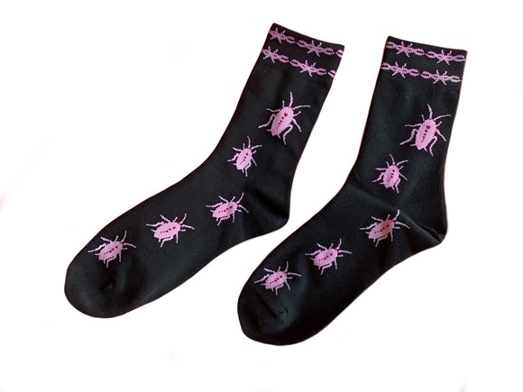 black crew socks with pink cock roaches crawling up the socks with pink Barbwire band on the top of it