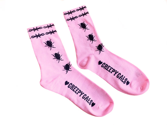 Pink crew socks with black cock roaches crawling up the socks with black Barbwire band on the top of it