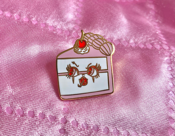 Gold plated pink and white slice of cake with face and a cherry on top enamel lapel pin