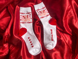White crew sock with a pink Angel teddy bear and Barbwire and heart designs. Red heart on heel