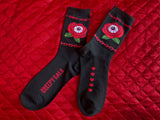 Black unisex size crew socks featuring a red rose with and eye and red Barbwire and chain detail
