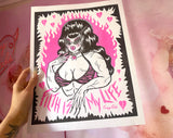 11x14” pink and black risograph print of a muscle lady with beehive hair and cat eye sunglasses surrounded by pink broken hearts with the words “Filth is My Life” under her
