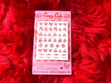 Sheet of pink and red nail decals featuring hearts, cherubs, devil, clown, cherries, and barbed wire 