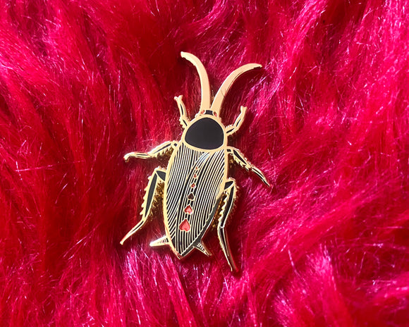 Gold plated cute black cockroach with red hearts enamel pin.