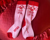Pink crew sock featuring Poopywise the clown on the front, red band on top, red toe tips and red heart on the heel