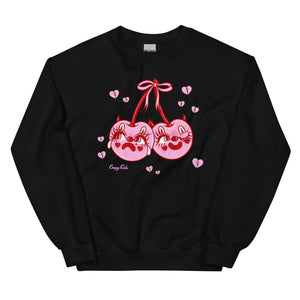 Red cotton and polyester unisex crew neck sweat shirt featuring kitschy pink devil cherries with clown makeup on. One cherry crying and the other winking. They are tied together with a pink bow and surrounded by pink broken hearts